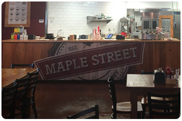 maple street biscuit company restaurant counter with printed wood front