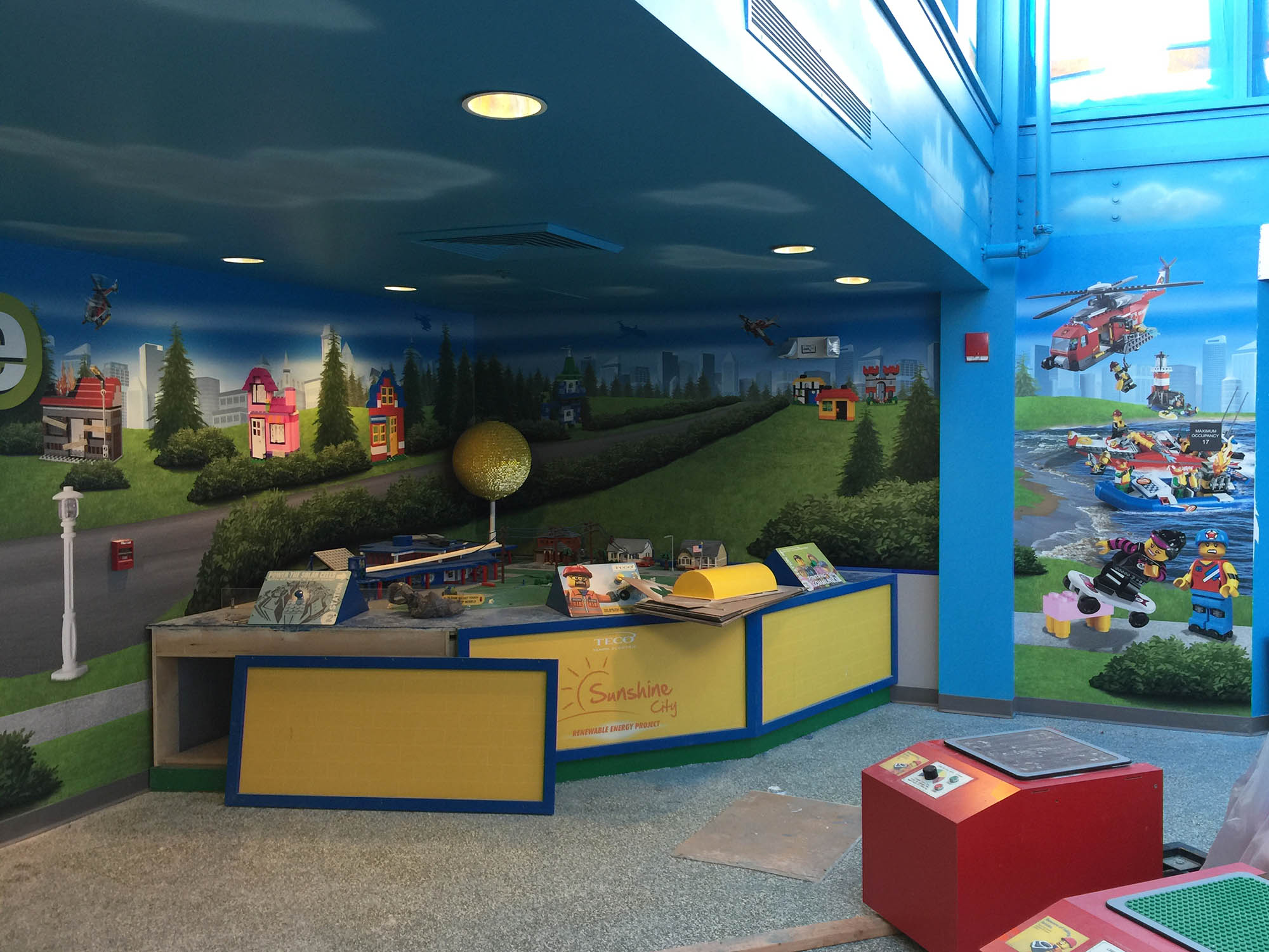Installing graphic wall wraps and counter wraps for Wheels Zone in Legoland Florida
